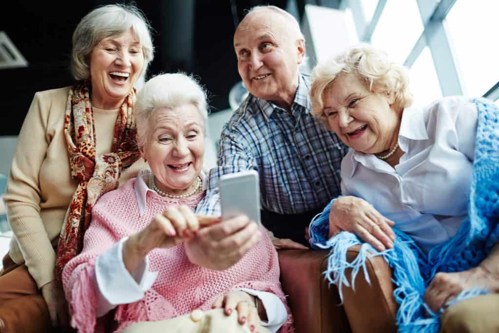 Laughing elderly women and man making selfie