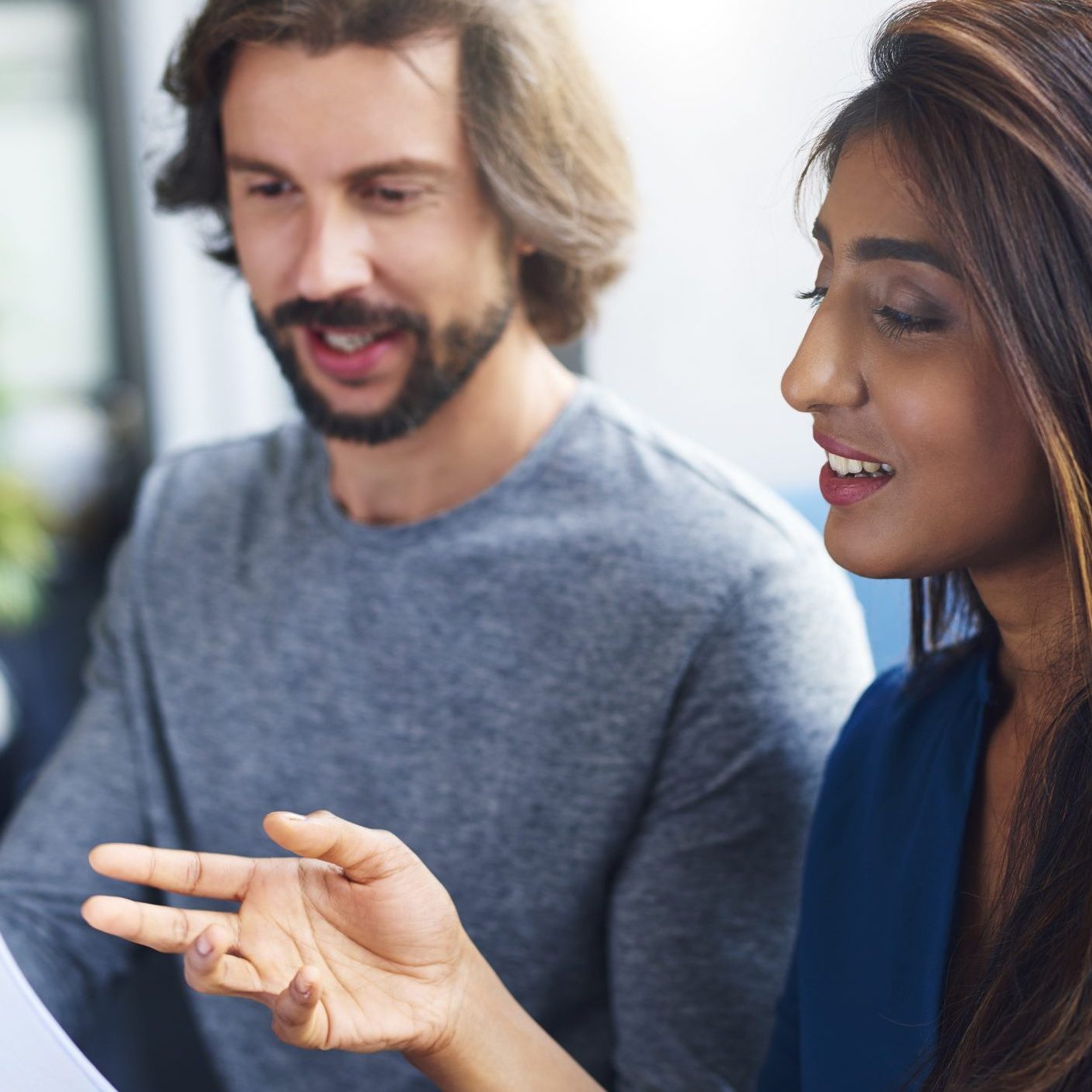 Young adults coworkers analyzing document